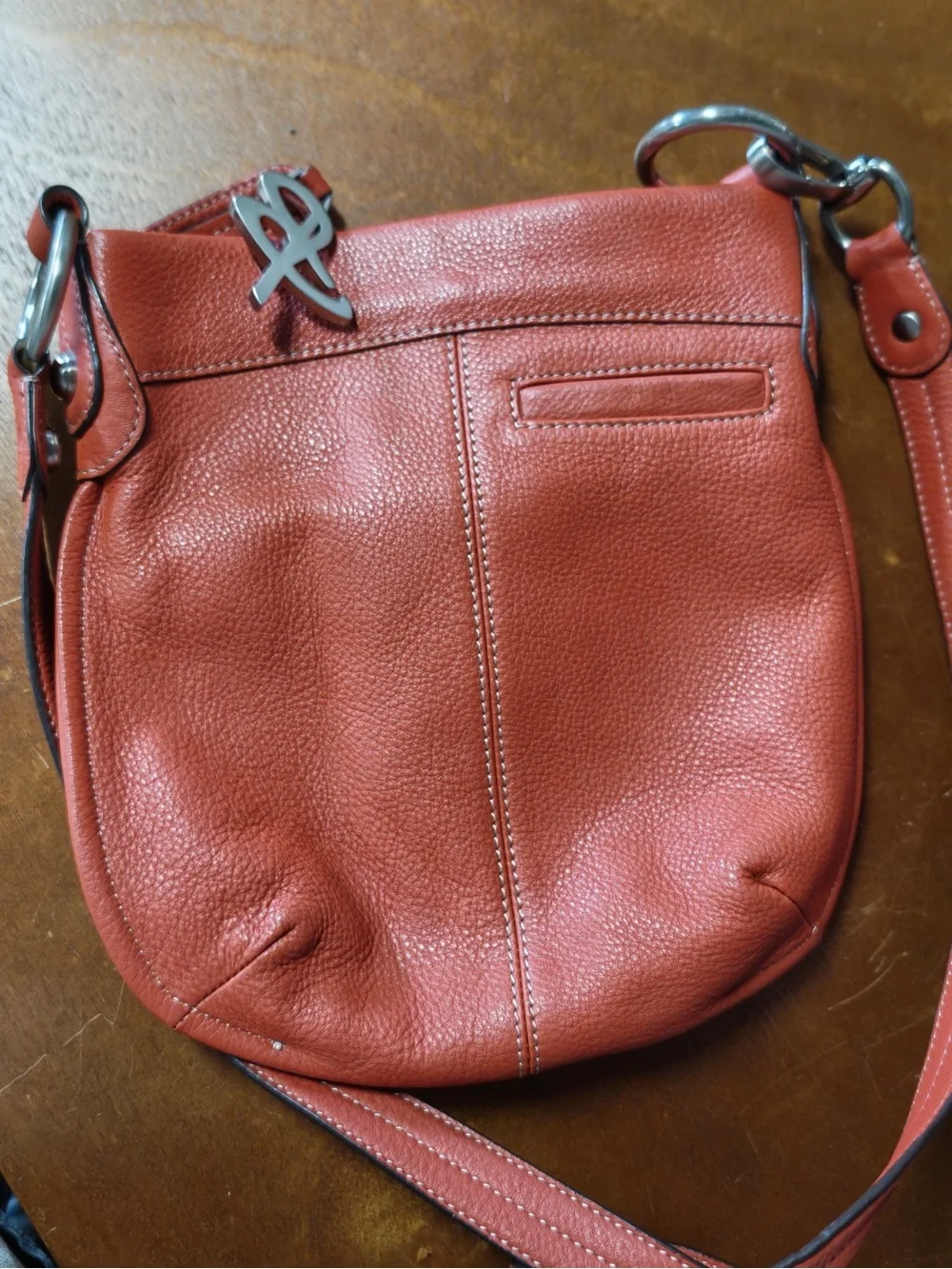 B. Makowsky Orange Leather Crossbody Bag with Silver Logo Charm